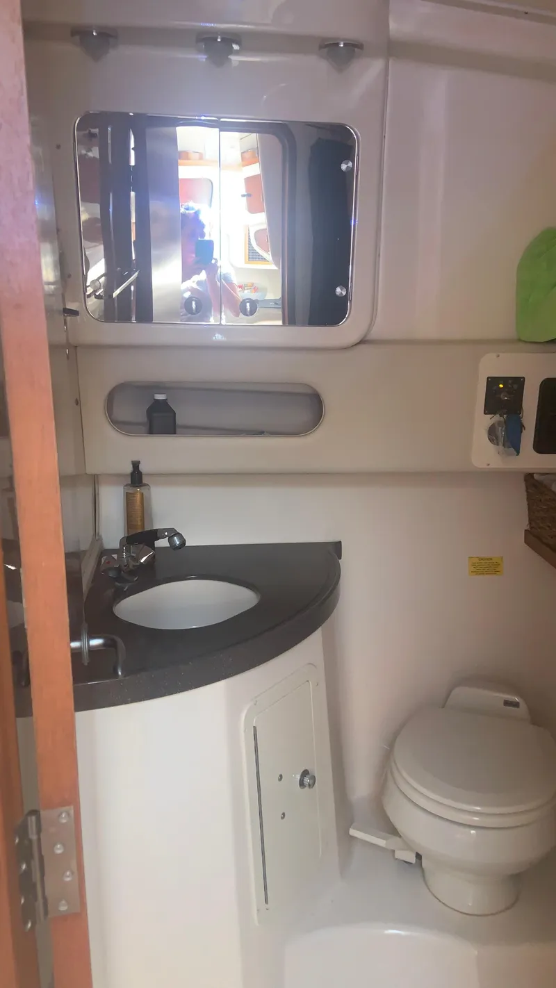 Slide: The Image of 2006 Grady-White 360 Express bathroom with sink, mirror, and toilet. - 33