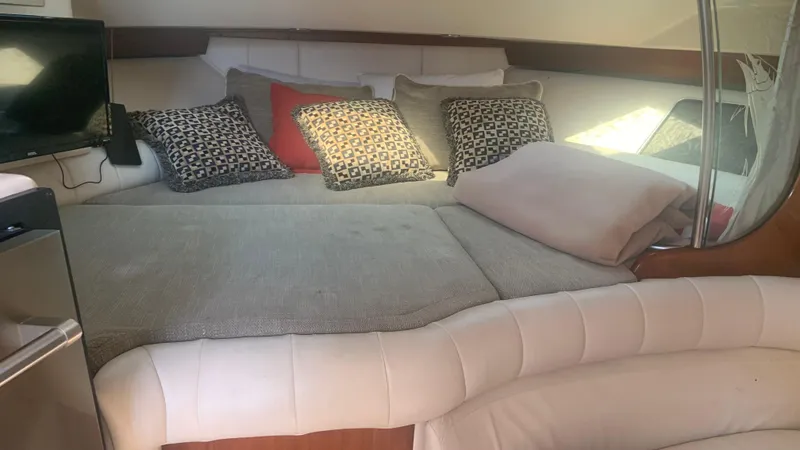 Slide: The Image of Interior of 2006 Grady-White 360 Express with cozy seating and decorative pillows. - 35