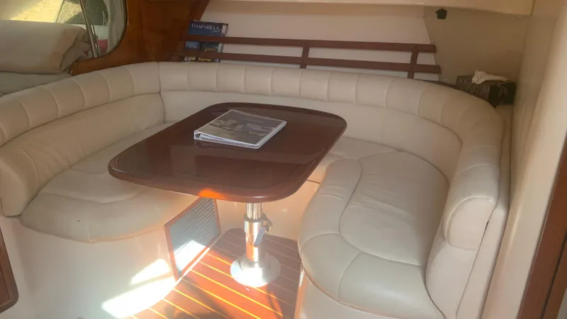 Slide: The Image of Interior of 2006 Grady-White 360 Express with beige seating and wooden table. - 38