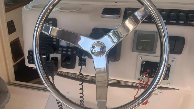 Slide: The Image of Steering wheel of 2006 Grady-White 360 Express boat, featuring control panel and instruments. - 44