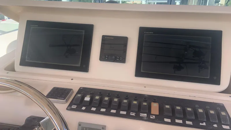 Slide: The Image of Control panel of 2006 Grady-White 360 Express boat with dual screens and switches. - 45