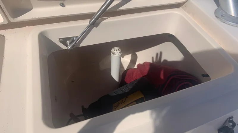 Slide: The Image of Storage compartment on a 2006 Grady-White 360 Express boat with items inside. - 46