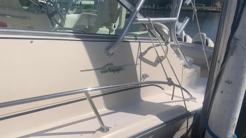 Slide: The Image of 2006 Grady-White 360 Express boat docked, featuring sleek design and sturdy railings. - 48