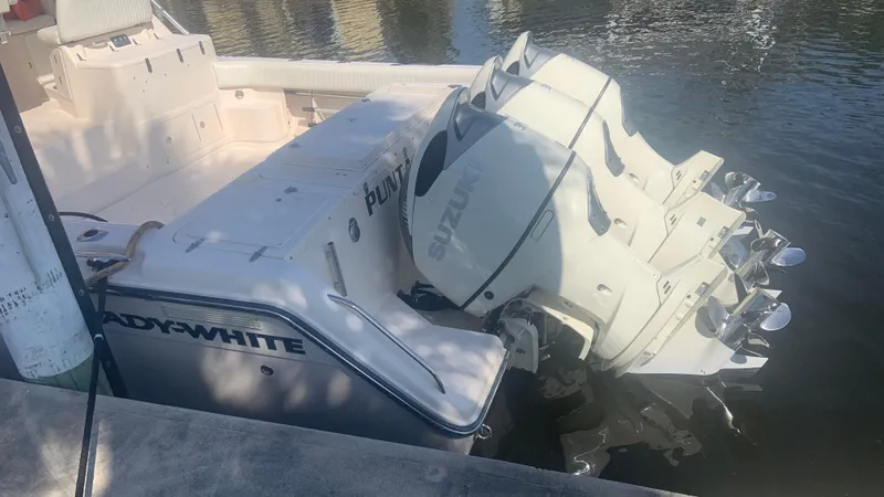 Slide: The Image of 2006 Grady-White 360 Express boat with dual Suzuki outboard engines docked in water. - 5