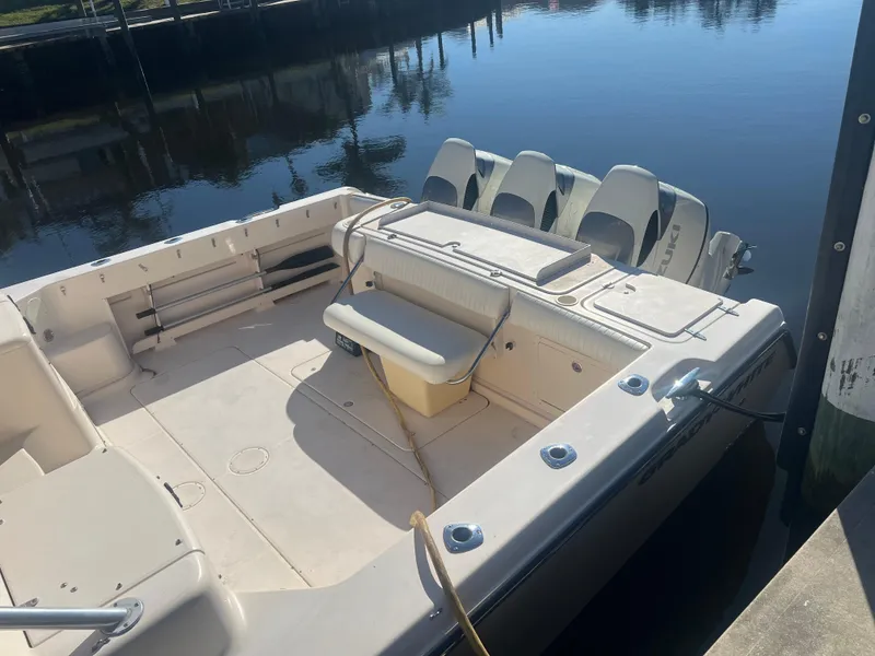 Slide: The Image of 2006 Grady-White 360 Express boat docked, featuring spacious deck and triple outboard engines. - 6