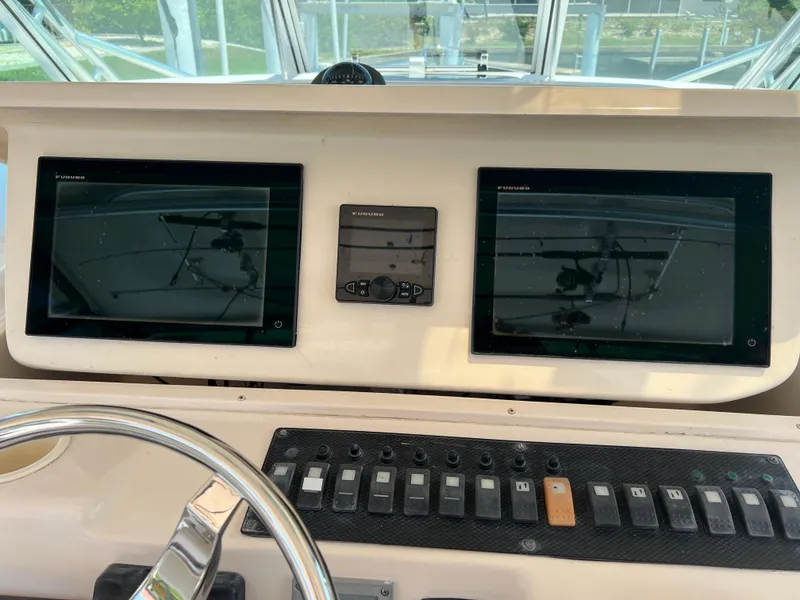 Slide: The Image of 2006 Grady-White 360 Express dashboard with dual screens and control panel. - 8