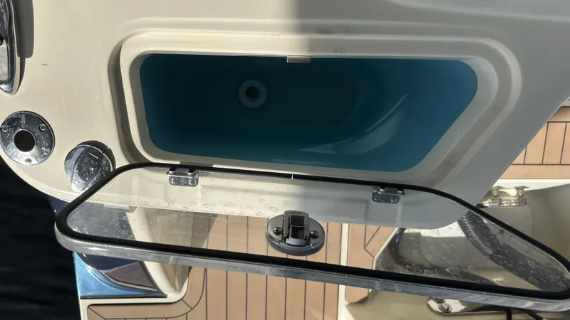 Slide: The Image of 2023 Chris-Craft Catalina 24 livewell with open lid, showcasing interior design. - 11