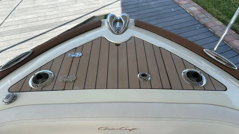 Slide: The Image of 2023 Chris-Craft Catalina 24 boat deck with wood finish and chrome fittings. - 13