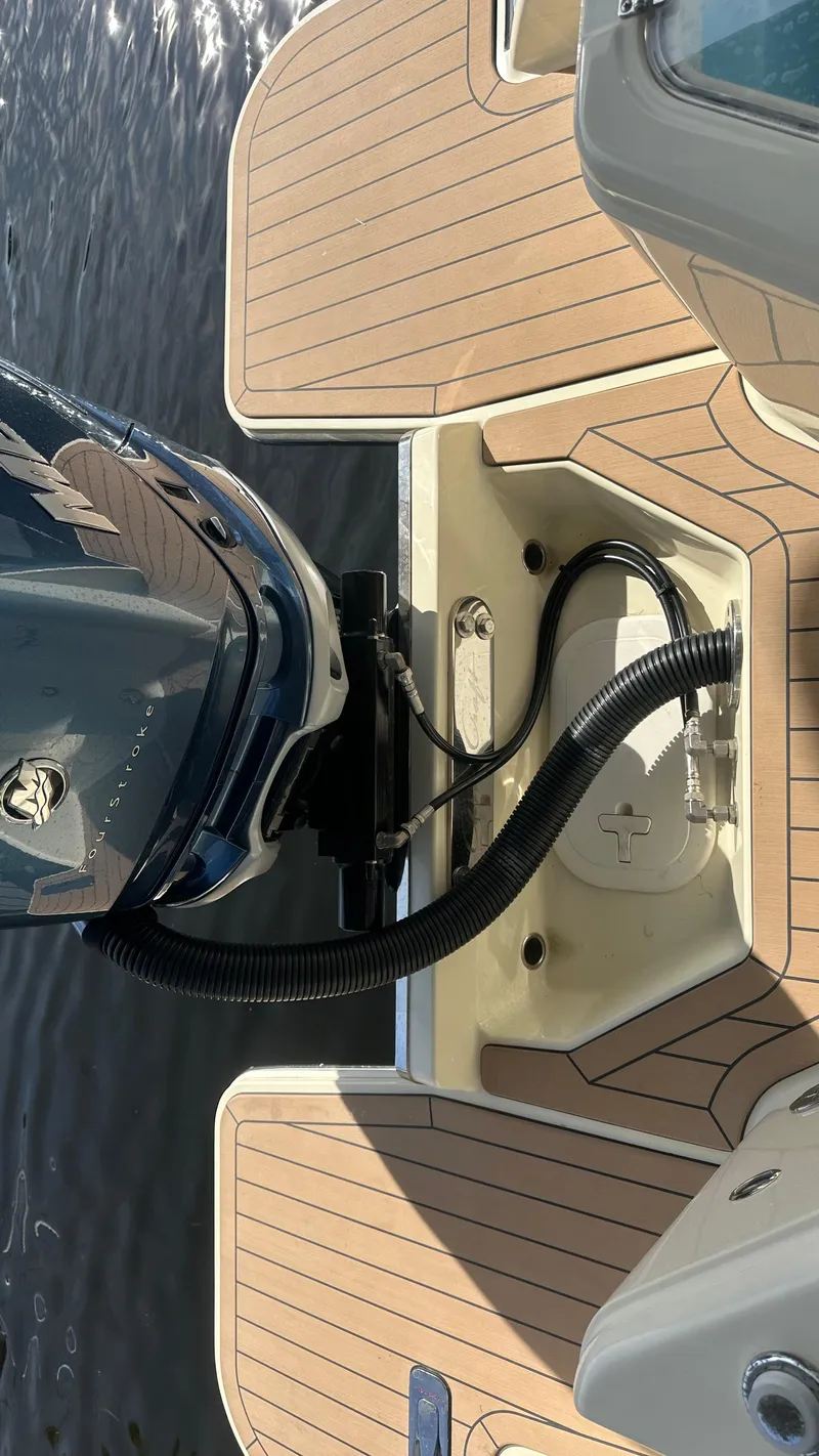 Slide: The Image of 2023 Chris-Craft Catalina 24 boat engine and deck detail on water. - 16