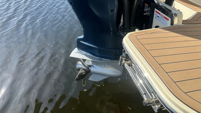 Slide: The Image of 2023 Chris-Craft Catalina 24 boat engine and swim platform on water. - 17