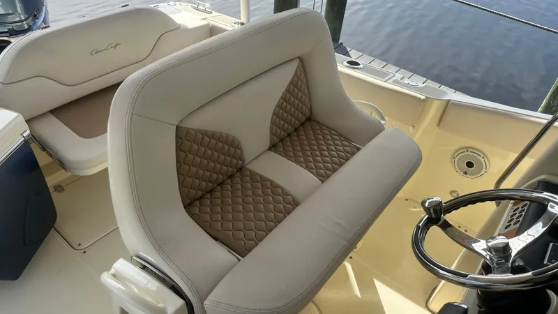 Slide: The Image of 2023 Chris-Craft Catalina 24 boat interior with stylish seating and steering wheel. - 22