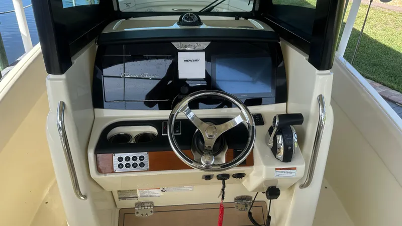 Slide: The Image of 2023 Chris-Craft Catalina 24 dashboard with steering wheel and controls. - 23