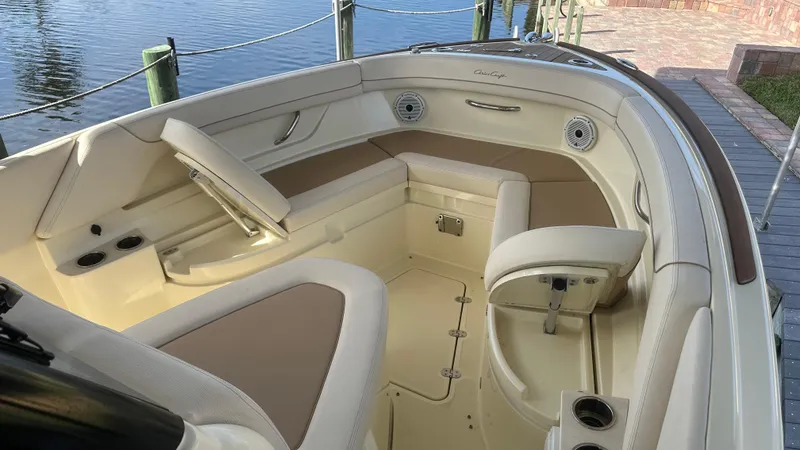 Slide: The Image of 2023 Chris-Craft Catalina 24 interior, featuring elegant seating and modern design by the water. - 27