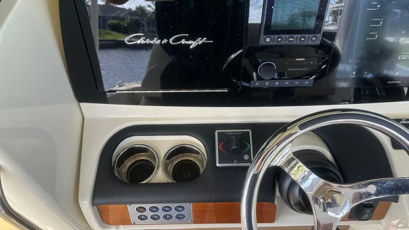 Slide: The Image of 2023 Chris-Craft Catalina 24 dashboard with steering wheel and controls. - 8