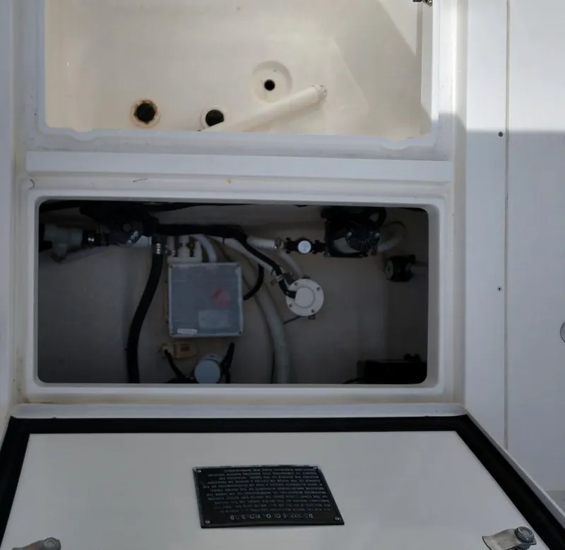 Slide: The Image of 2009 Intrepid 310 WA boat compartment with visible plumbing and wiring. - 10