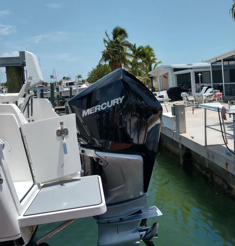 Slide: The Image of 2009 Intrepid 310 WA boat with Mercury outboard motor docked by waterfront homes. - 12