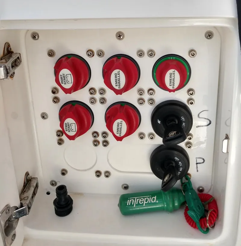 Slide: The Image of Control panel of a 2009 Intrepid 310 WA boat with switches and keys. - 13