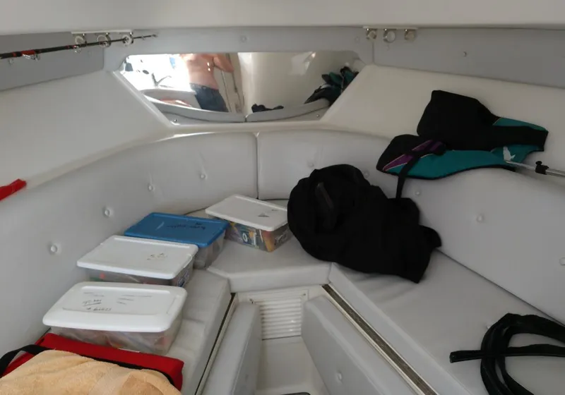 Slide: The Image of Interior cabin of 2009 Intrepid 310 WA boat with storage containers and seating. - 14