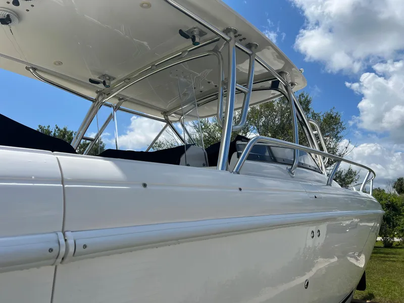 Slide: The Image of 2009 Intrepid 310 WA boat, sleek design, white exterior, clear sky background. - 20