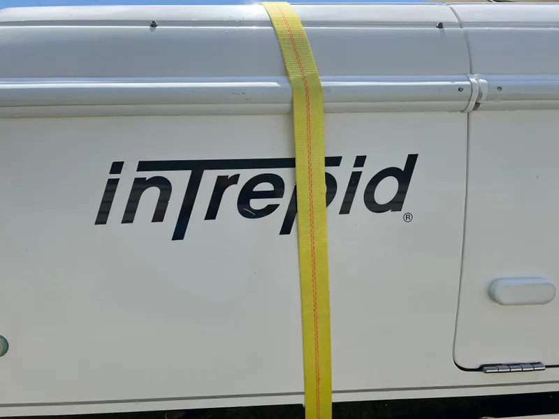 Slide: The Image of 2009 Intrepid 310 WA boat with yellow strap on side. - 22