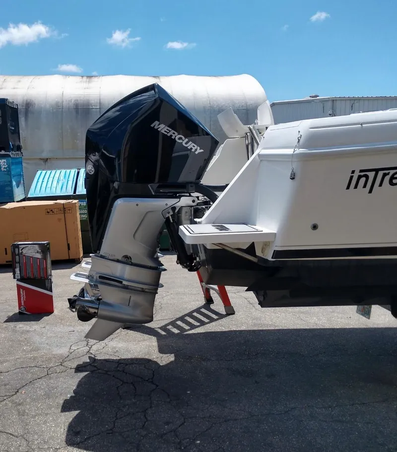 Slide: The Image of 2009 Intrepid 310 WA boat with Mercury outboard engine, docked outdoors. - 3