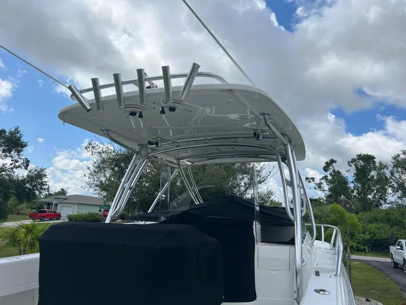 Slide: The Image of 2009 Intrepid 310 WA boat with covered seating, under a cloudy sky. - 31
