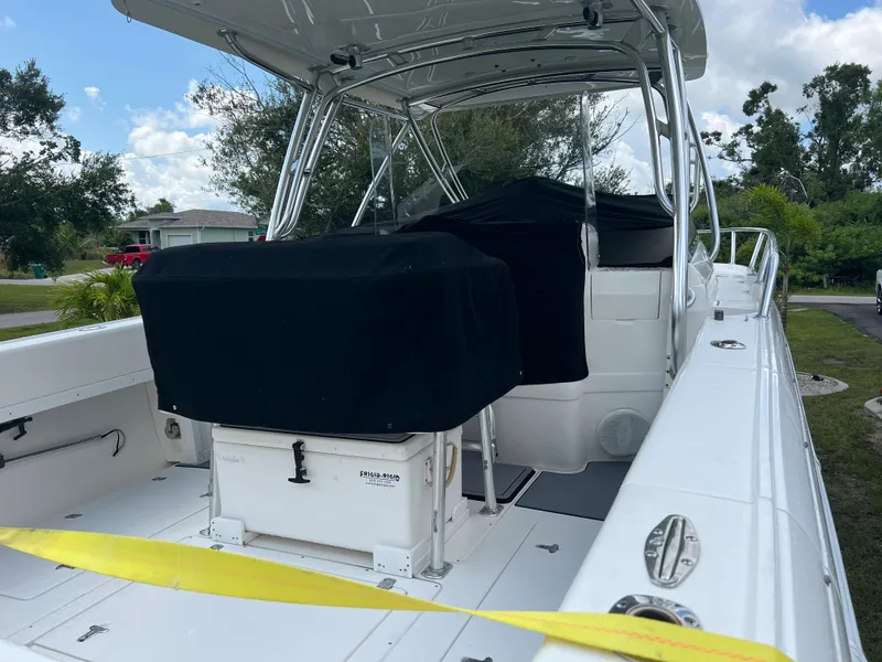 Slide: The Image of 2009 Intrepid 310 WA boat with covered seating, docked outdoors. - 32