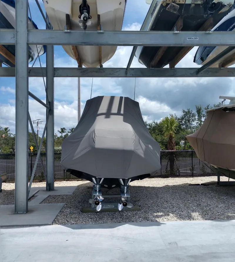 Slide: The Image of Covered 2009 Intrepid 310 WA boat stored on a rack outdoors. - 33