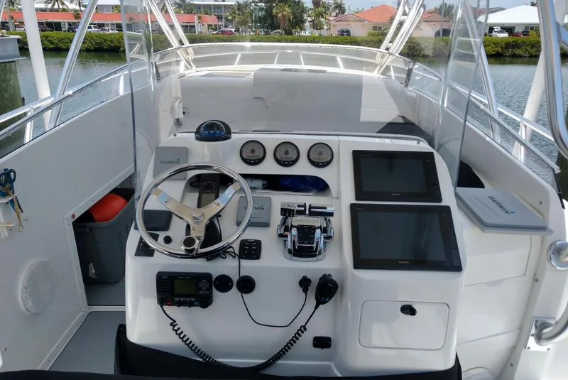 Slide: The Image of 2009 Intrepid 310 WA boat dashboard with steering wheel and navigation screens. - 4