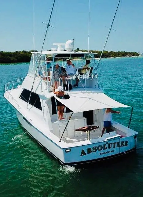 Slide: The Image of 1998 Viking 43 Convertible yacht cruising on clear blue water. - 21