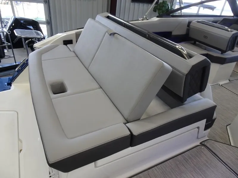 Slide: The Image of 2025 Cobalt R4 boat interior with gray seating and cup holder. - 10