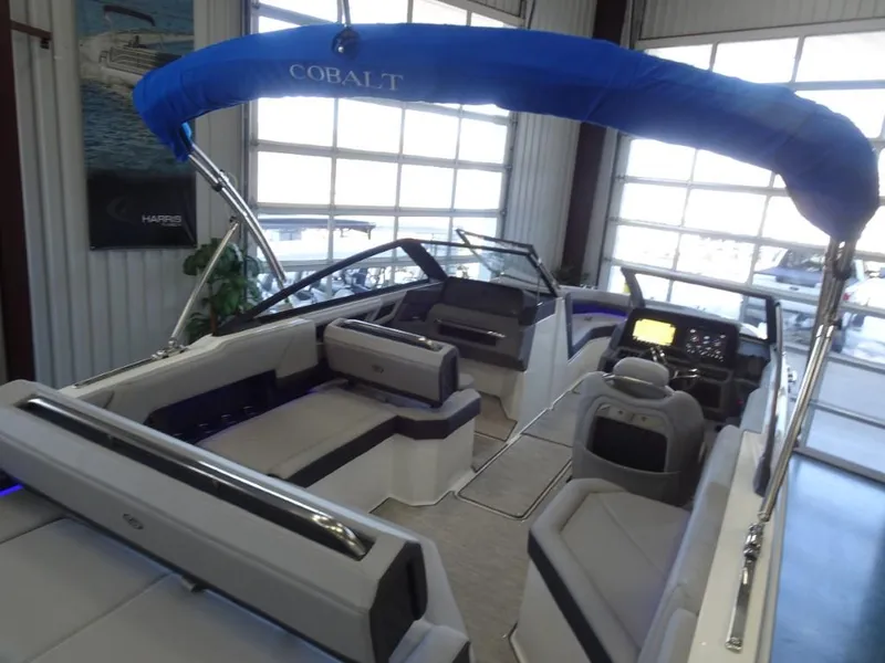 Slide: The Image of 2025 Cobalt R4 boat interior with seating and control panel in showroom. - 11
