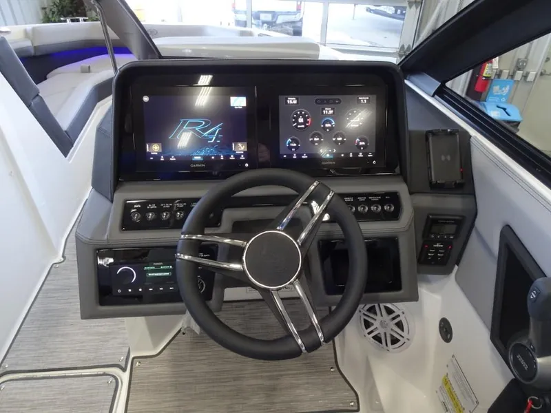 Slide: The Image of 2025 Cobalt R4 boat dashboard with dual screens and modern steering wheel. - 16