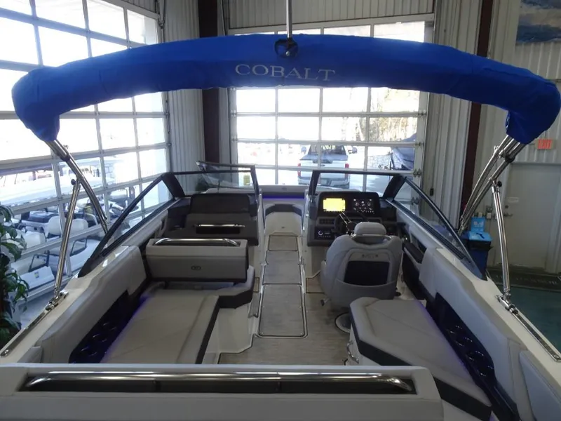 Slide: The Image of 2025 Cobalt R4 boat interior with blue canopy, modern dashboard, and spacious seating. - 7