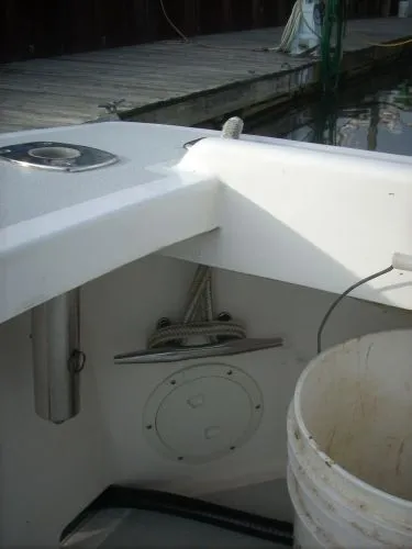 Slide: The Image of The image shows the stern of a 2000 Duffy Flybridge Sportfisherman with ropes and a bucket. - 13