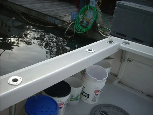 Slide: The Image of The image shows the stern of a boat with fishing rod holders and buckets. - 16