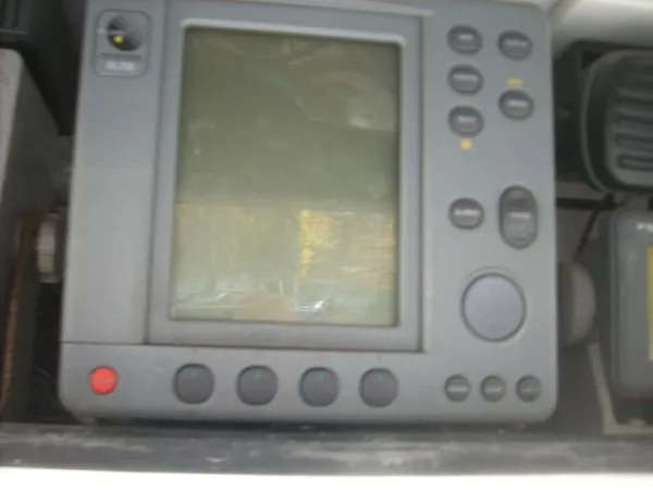 Slide: The Image of A navigation device with multiple buttons and a screen, installed on a boat. - 34