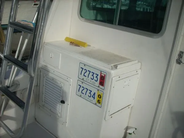 Slide: The Image of The image shows the stern of a 2000 Duffy Flybridge Sportfisherman with fishing gear. - 14