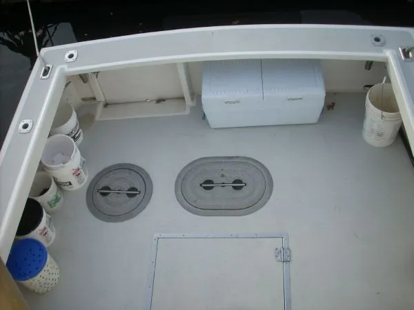 Slide: The Image of The image shows the deck of a 2000 Duffy Flybridge Sportfisherman with buckets and storage compartments. - 45