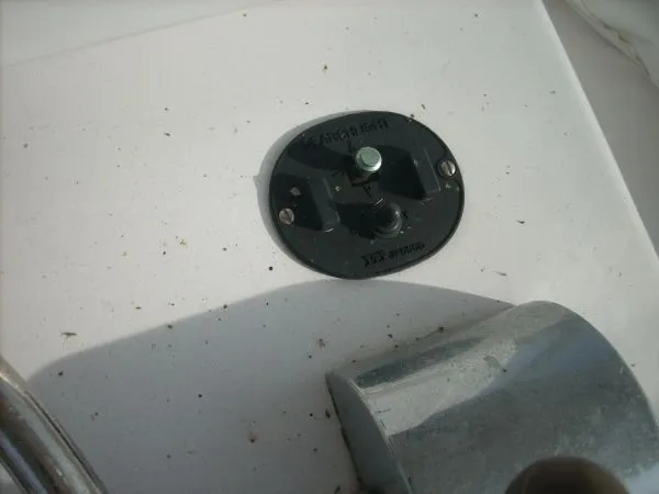 Slide: The Image of Close-up of a boat component with a black round cover and a metal part beside it. - 27