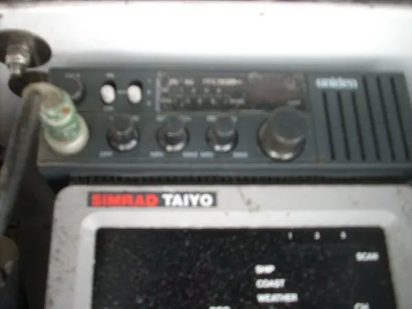 Slide: The Image of A Uniden radio and a Simrad Taiyo device are mounted on a boat. - 29