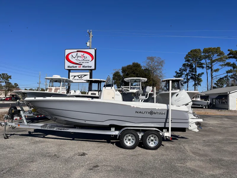 The Image of 2025 NauticStar 211 Hybrid boat on trailer at dealership. - 0