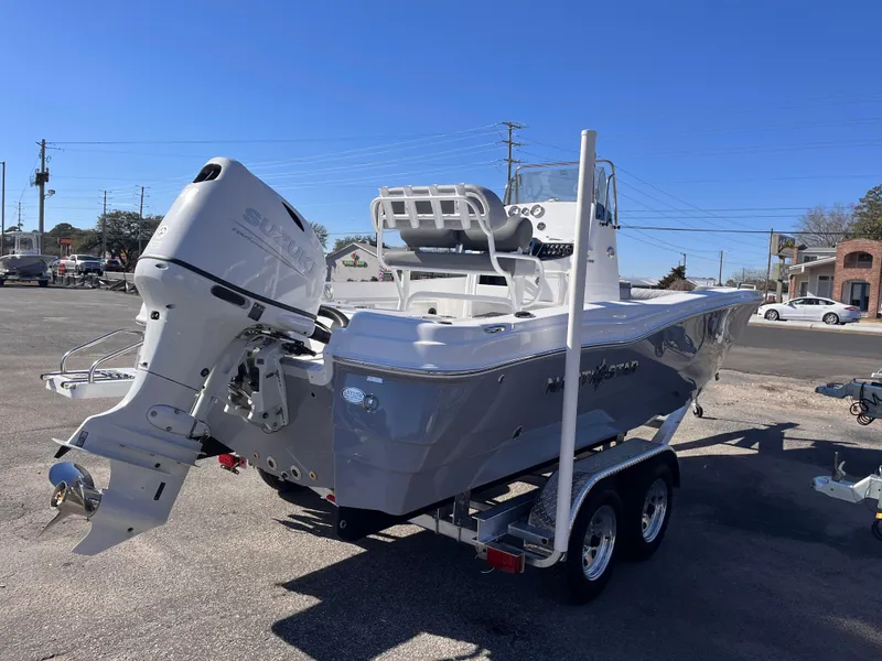 Slide: The Image of 2025 NauticStar 211 Hybrid boat on trailer, featuring sleek design and powerful outboard motor. - 4