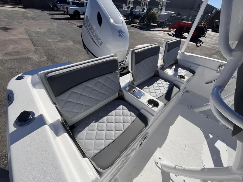 Slide: The Image of 2025 NauticStar 211 Hybrid boat interior with gray quilted seats and cup holders. - 6