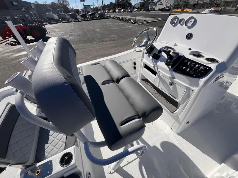 Slide: The Image of 2025 NauticStar 211 Hybrid boat interior with modern console and seating. - 7
