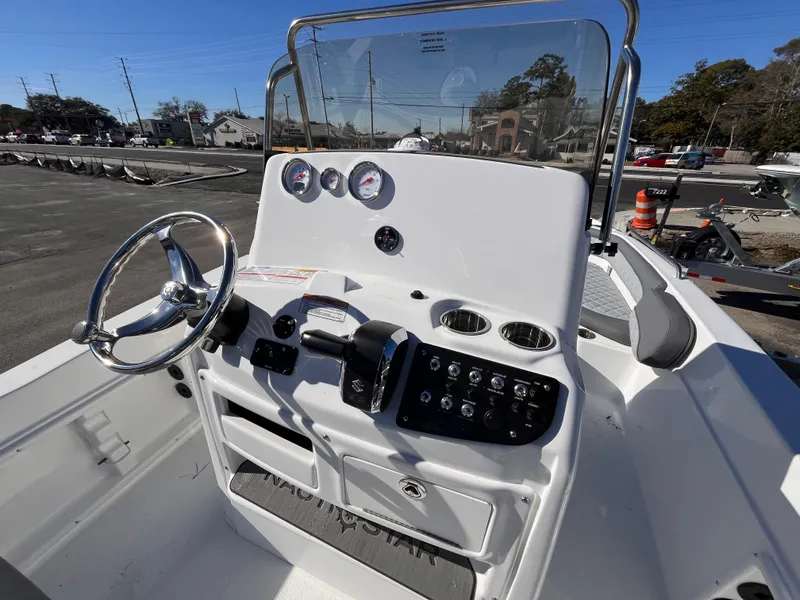 Slide: The Image of 2025 NauticStar 211 Hybrid boat console with steering wheel and control panel. - 8