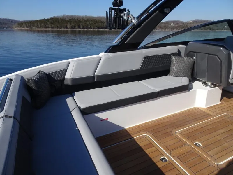 Slide: The Image of 2025 Cobalt R33 Surf boat interior with sleek seating and wooden deck. - 12
