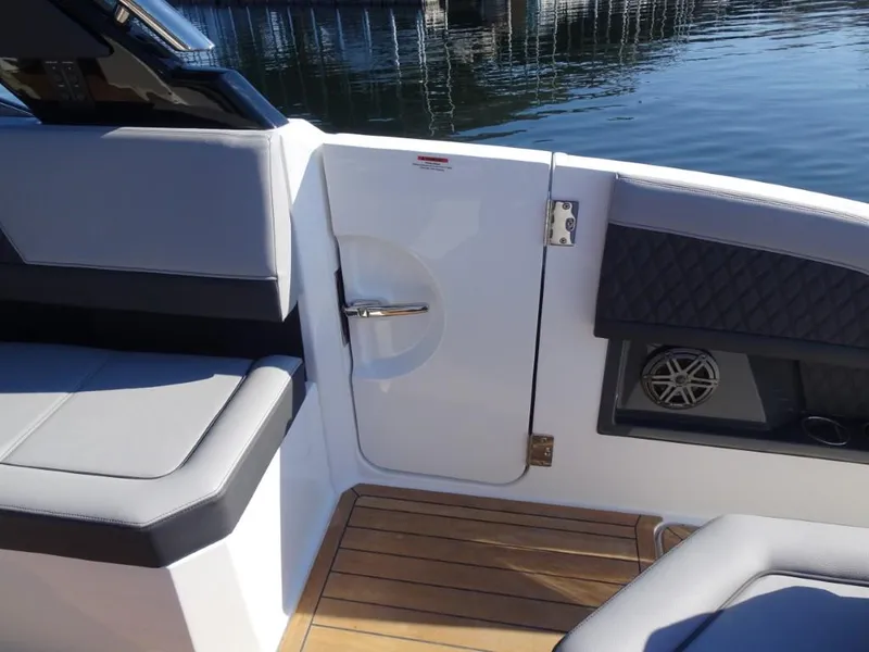 Slide: The Image of Cobalt R33 Surf 2025 boat interior with sleek seating and wooden flooring. - 14