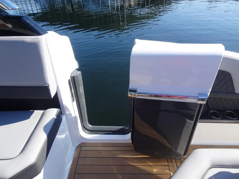 Slide: The Image of 2025 Cobalt R33 Surf boat interior with open door and water view. - 15