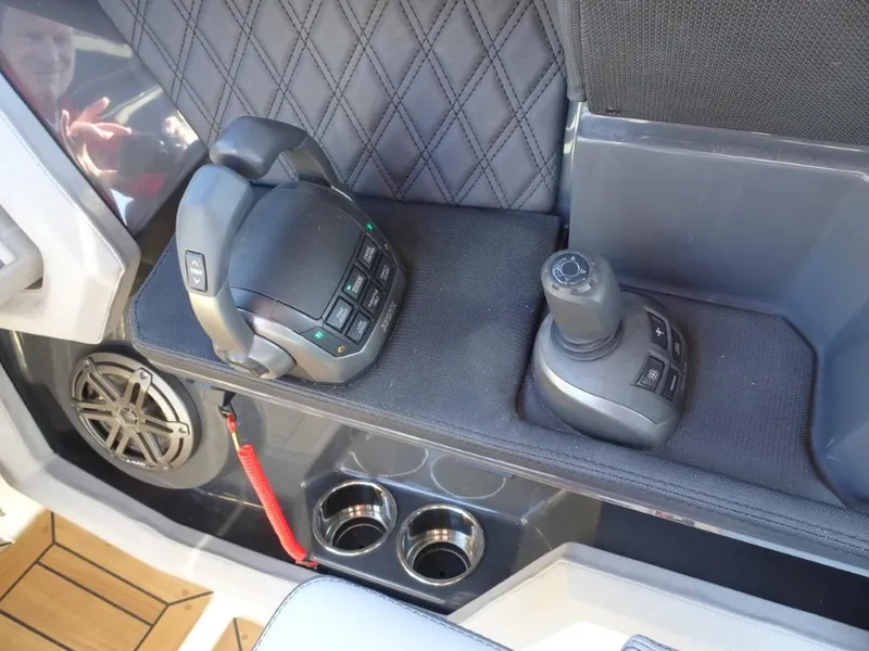 Slide: The Image of Interior controls of 2025 Cobalt R33 Surf boat, featuring joystick and speaker. - 22